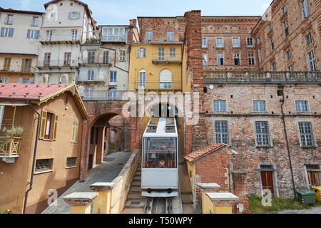 MONDOVI, ITALY - AUGUST 18, 2016: Funicular train and ancient buildings in a sunny summer day in Mondovi, Italy. Stock Photo