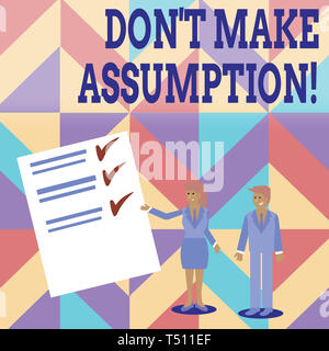 Conceptual hand writing showing Don T Make Assumption. Concept meaning something that you assume to be case even without proof Man and Woman Presentin Stock Photo