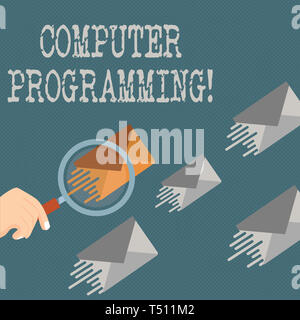 Writing note showing Computer Programming. Business concept for process that instructs a computer on how to do a task Magnifying Glass on Color Envelo Stock Photo