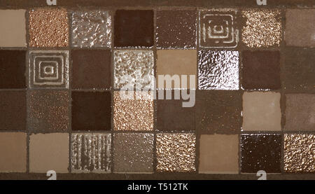 Brown square mosaic tiles on bathroom wall texture background
