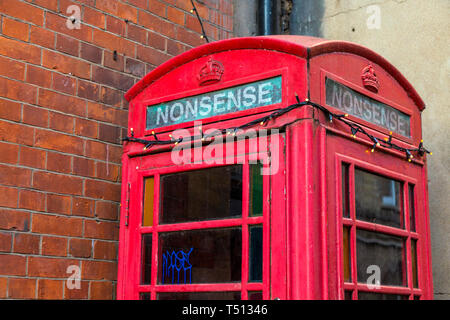 Red Grade II listed telephone box on Pembroke Street with the word Nonsense inscribed, Oxford, UK Stock Photo