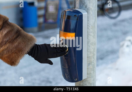 Female hand pushing button for traffic light Stock Photo
