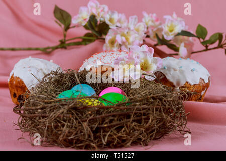 Easter eggs and Easter cake in basket with colorful decorated in rainbow of colors Stock Photo