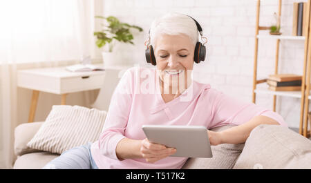 Senior woman playing video games on her laptop Stock Photo