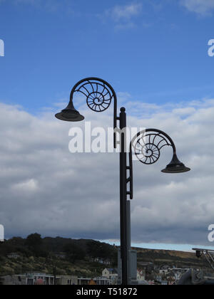 Jurassic Coast Lamp post against cloudy sky in Lyme Regis, Dorset, UK Stock Photo