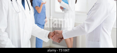 Deal! Concept of collaboration in medicine. Doctors shaking hands Stock Photo