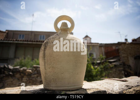 Large ceramic spanish clay jug resting on a wall. Stock Photo