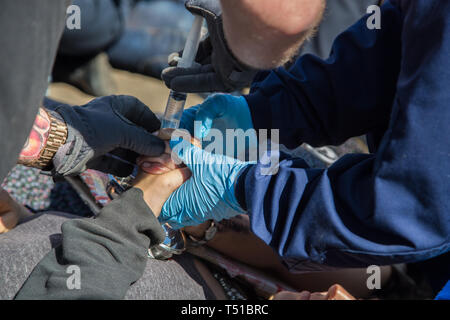 London UK 19th Apr 2019 Police inject a solvent in to the palms of two  Environmentalist who had glued their hands together. Stock Photo