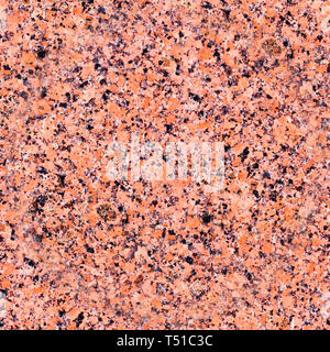 seamless red granite with black spots background. texture, pattern. Stock Photo