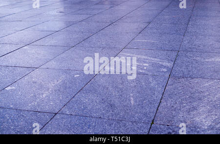 wet pavement of blue tiles in the park at rainy day. background, decoration. Stock Photo
