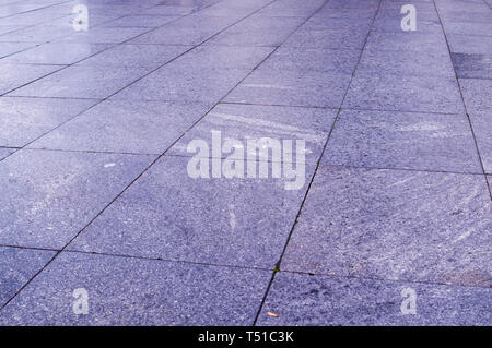 wet pavement of blue tiles in the park at rainy day. background, decoration. Stock Photo