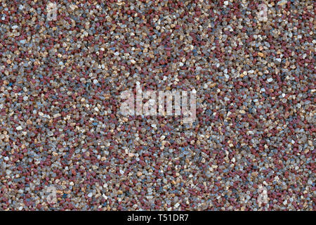 Texture decorative plaster on the basis of small colored marble stones and acrylic adhesive composition, close-up abstract background, close up. Mix o Stock Photo