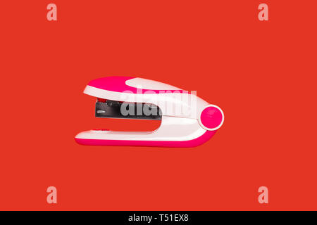 stapler on a red background Stock Photo