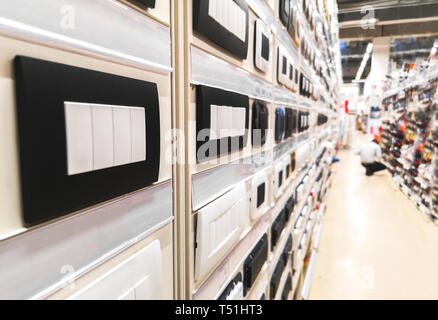 home improvement center storehouse aisle with light switches and sockets  plate covers in hardware store Stock Photo