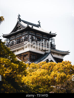 Hiroshima Castle covered in cherry blossoms and flowers Stock Photo