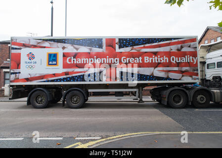 An Aldi - a German supermarket brand - truck passing through Omskirk, West Lancashire, with an image championing British products, Great Britain. Stock Photo