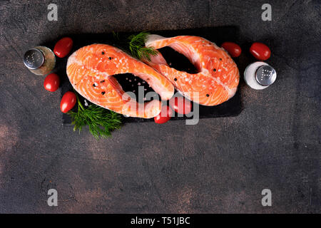 Fresh two raw salmon steaks on dark background Stock Photo