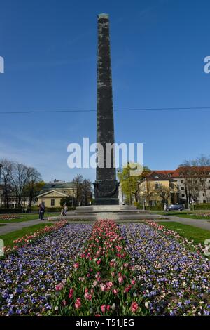 Obelisk with flower bed in front of houses roundabout, Karolinenplatz, Munich, Bavaria, Germany Stock Photo