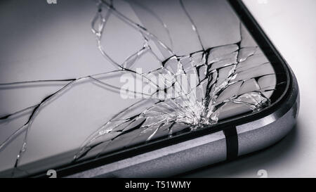 Broken mobile phone screen close up. Weak glass in modern gadgets Stock Photo
