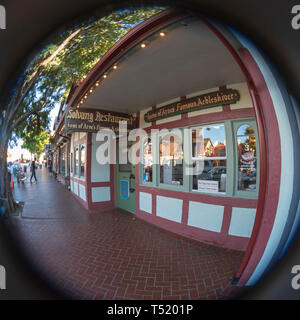 Sidewalk view of restaurant store front with signs. Brick sidewalk. Stock Photo