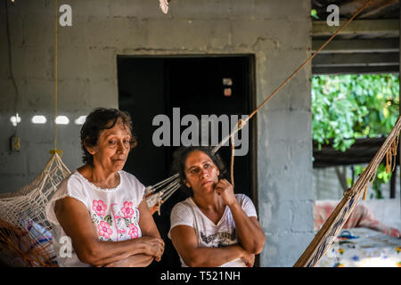 elderly latin woman standing in Guatemalan house Stock Photo