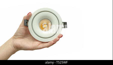 Close up woman hand holding modern Led lamp. Isolated on a white background Stock Photo