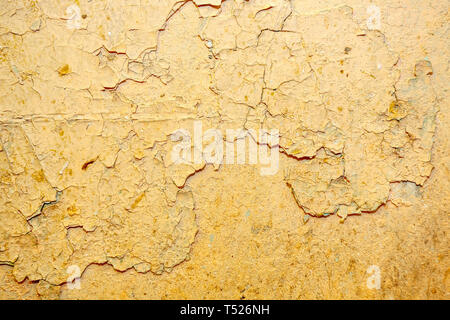 Peeling beige  paint on the wall Stock Photo