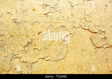 Peeling beige  paint on the wall Stock Photo