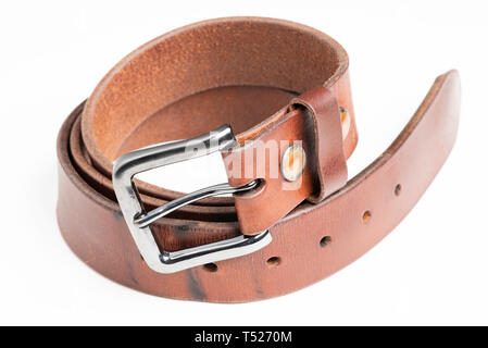 A close-up studio product shot of a used thick men’s belt showing the beautiful patina of its leather. Stock Photo