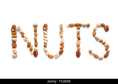 Nuts Spelling The Word Nuts isolated on white. Various nuts (almonds, pistachios, pecans, hazelnuts, pine nuts, peanuts). Stock Photo