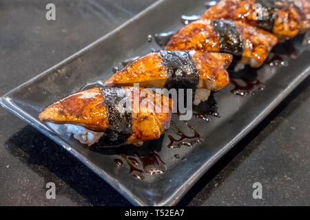 Foie gras sushi with sauce served on plate Stock Photo