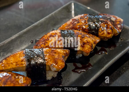 Foie gras sushi with sauce served on plate Stock Photo