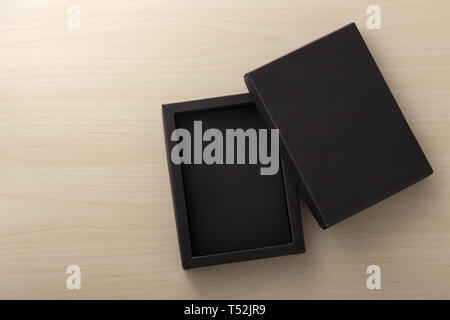 Opened black box packaging on wooden background, mockup Stock Photo