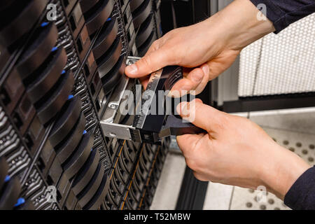 IT Professional Replacing Hard Disk In San At Datacenter Stock Photo