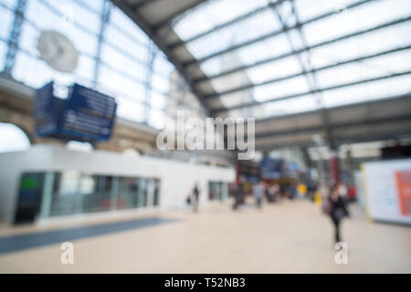 Blurred image bokeh of People walking inside Liverpool Lime Street Train Station. Stock Photo