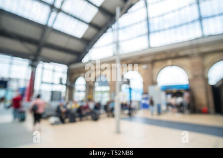 Blurred image bokeh of People walking inside Liverpool Lime Street Train Station. Stock Photo