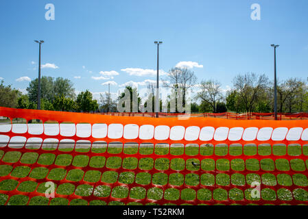 Orange plastic safety netting barrier used at a construction site. Stock Photo