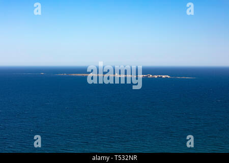 panoramic view of Tabarca island from the Santa Pola lighthouse in Alicante, Spain, on an intense blue mediterranean sea and clear sky Stock Photo