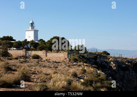 white mediterranean lighthouse of Santa Pola with the coast of Alicante in the background Stock Photo