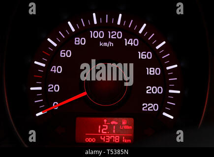 Car speedometer dial with red backlit close-up Stock Photo