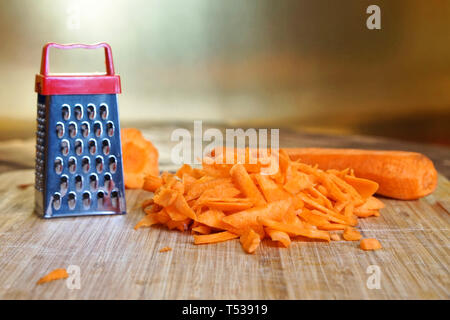 Premium Photo  Shredding grater and shredded carrots on a cutting