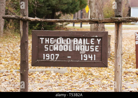 The Old Baily School House sign. 1907-1941. A one-room log schoolhouse built in 1907. It is now part of Sturgeon Point State Park. Harrisville, Michig Stock Photo