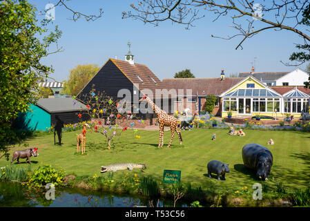 Marie's Garden in Heybridge Basin, Essex, UK on a bright sunny day. Quirky private garden full of jungle animal features including giraffe, hippo Stock Photo
