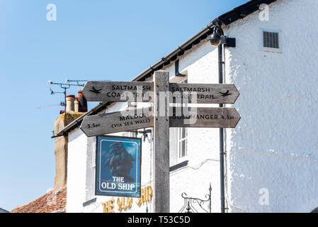 Saltmarsh Coast Trail and local destination signpost at Heybridge Basin, Essex, UK on a bright sunny day. Goldhanger and Maldon directions Stock Photo