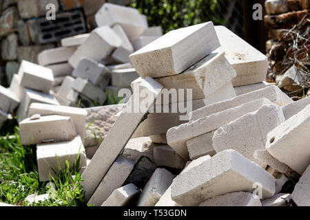 A pile of construction waste is in the yard. White brick or foam block. Stock Photo