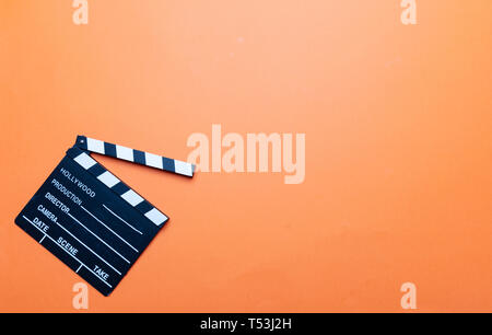 Cinama film concept. Movie clapper board on orange color background, copy space Stock Photo