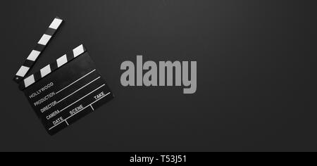 Cinama film concept. Movie clapper board on black color background, banner, copy space Stock Photo