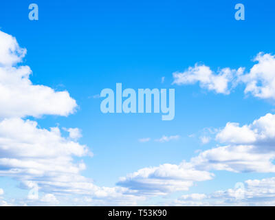 wedge of white clouds in blue sky in sunny spring day Stock Photo