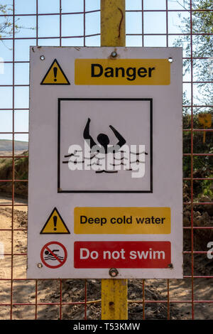 Danger Deep Cold Water warning sign on a quarry gate Stock Photo