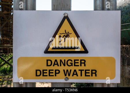 Danger Deep Water warning sign on a quarry gate Stock Photo